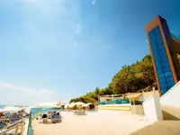 Plaża z leżakami i parasolami w A Good Life Utopia Family Resort