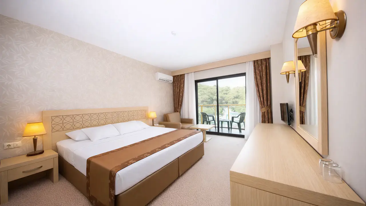 Przytulny pokój z łóżkiem w Alder Resort