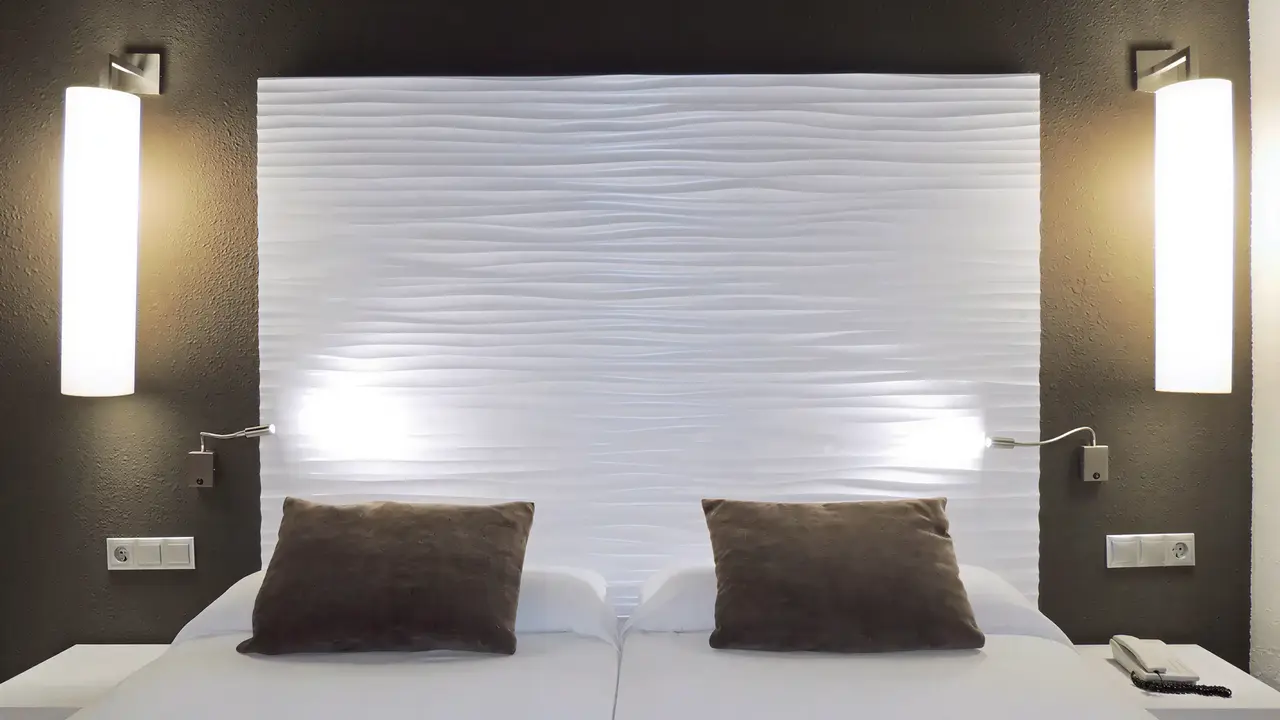 Łóżko w pokoju hotelowym w Augustus
