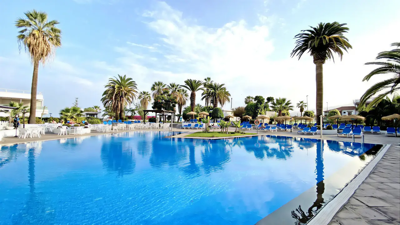 Basen z leżakami i palmami w Blue Sea Interpalace