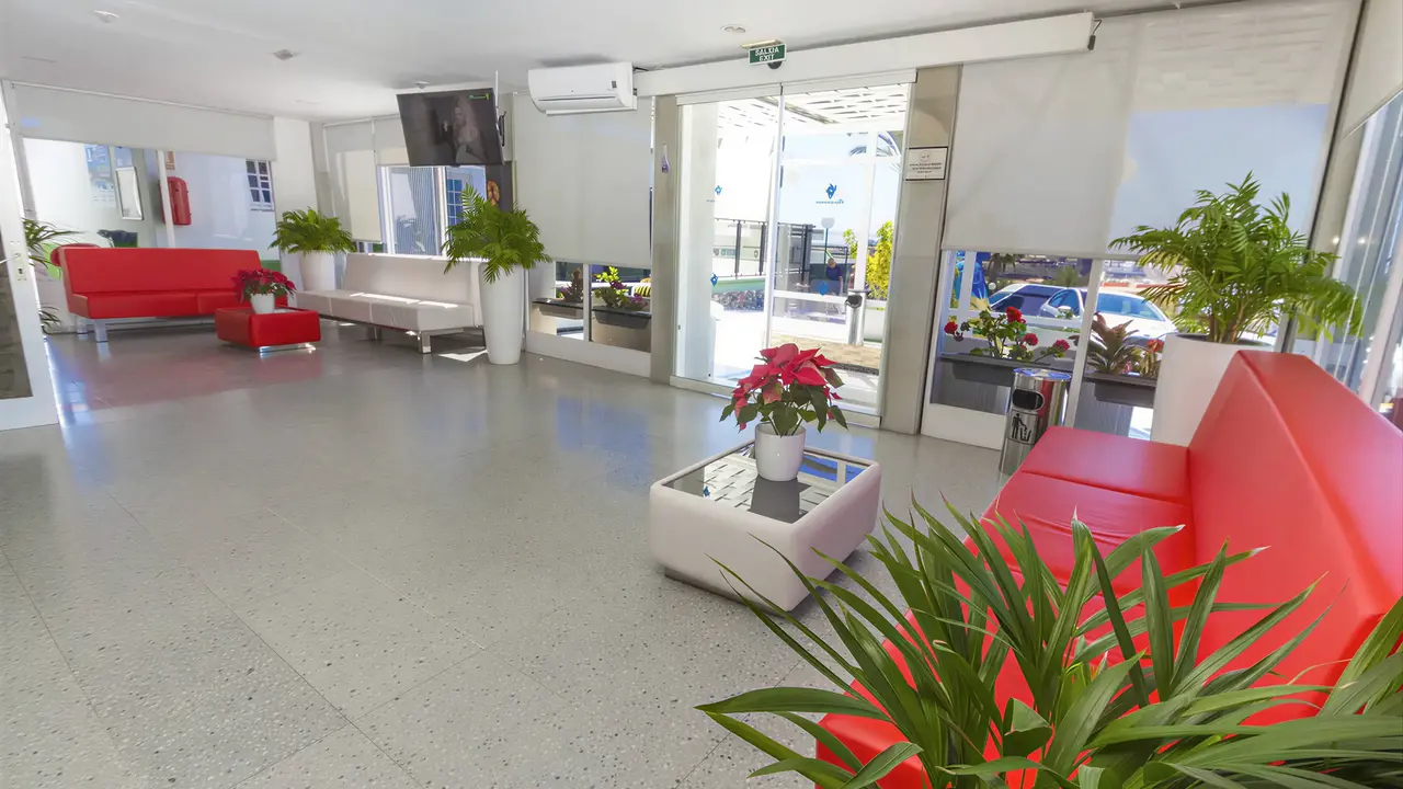 Wnętrze lobby z czerwonymi sofami w Bungalows Vista Oasis