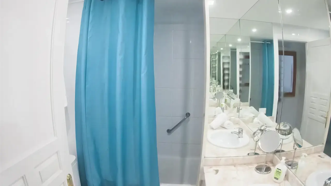 Łazienka w hotelu Coral Teide Mar z niebieską zasłoną