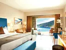 Sypialnia z widokiem na morze w Daios Cove Luxury Resort & Villas