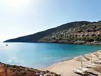 Plaża z parasolami i leżakami w Daios Cove Luxury Resort & Villas