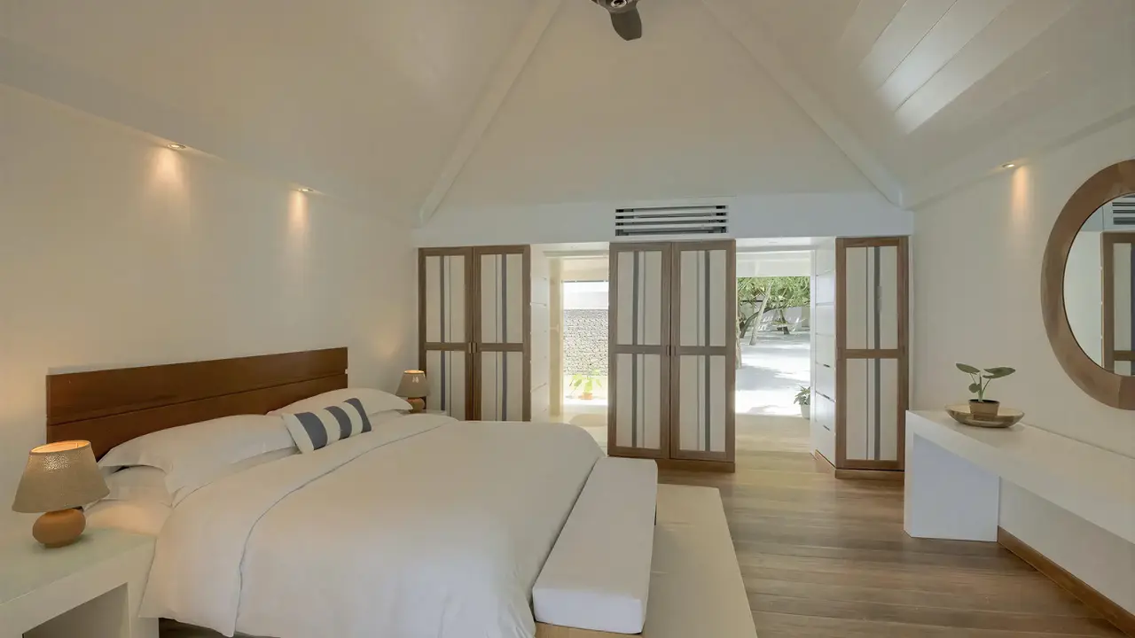 Jasna sypialnia w Diamonds Athuruga Beach & Water Villas z dużym łóżkiem