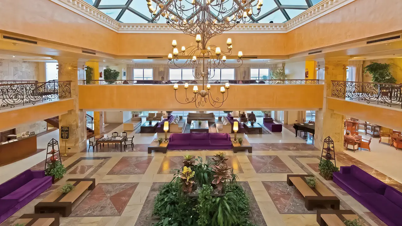 Luksusowe lobby z fioletowymi sofami w Elba Estepona Gran Hotel Thalasso & Spa