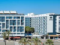 Elewacja budynku Gran Hotel Flamingo z palmami przed wejściem
