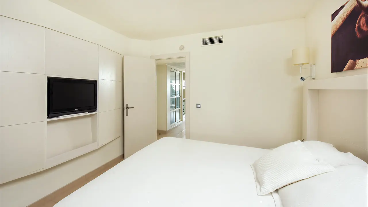 Jasna sypialnia z łóżkiem w Iberostar Waves Club Cala Barca