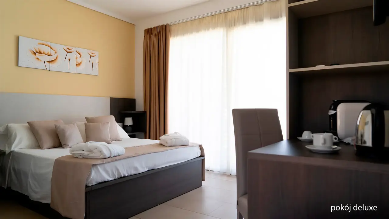 Wnętrze pokoju deluxe w La Conchiglia Suites & Spa