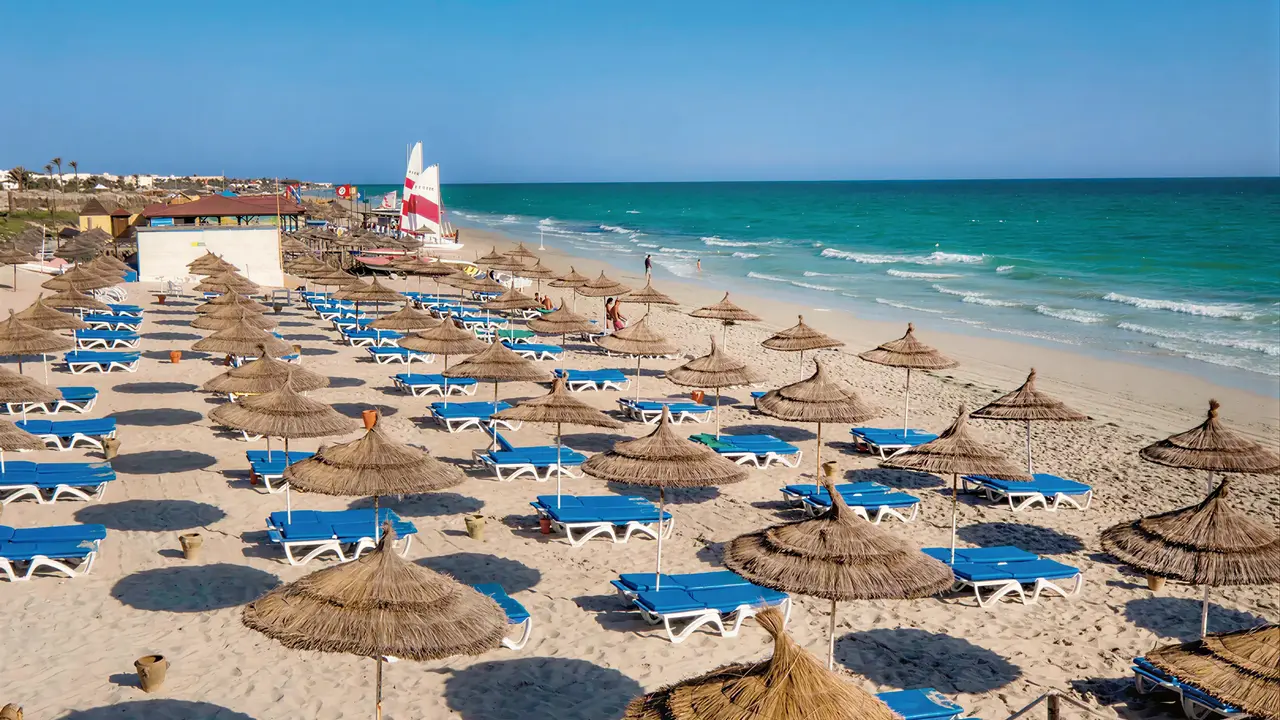 Plaża z leżakami i parasolami w Les Quatres Saisons by Medina