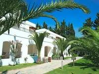 Biały budynek Marvida Senses Very Chic wśród zielonych palm