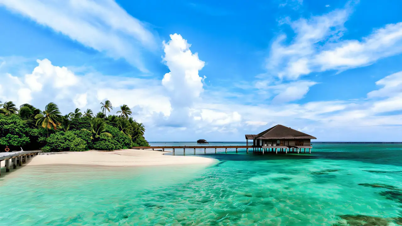Biała plaża i turkusowa woda w Medhufushi Island Resort