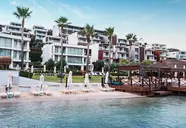 Widok na kompleks budynków Mivara Luxury Resort & Spa Bodrum nad wodą