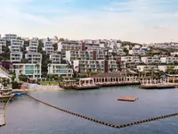 Widok na kompleks budynków Mivara Luxury Resort & Spa Bodrum nad wodą