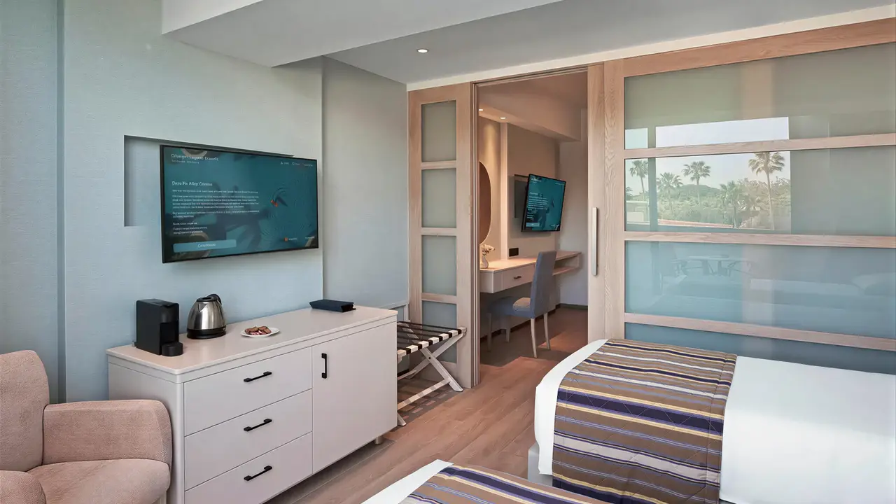 Pokój z łóżkami i telewizorem w Olympic Lagoon Resort Paphos