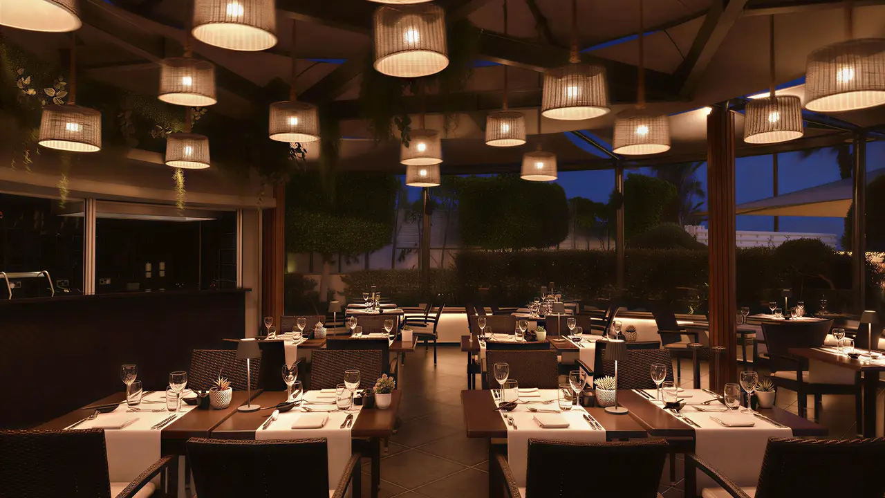 Elegancka restauracja w Olympic Lagoon Resort Paphos z nakrytym stołami