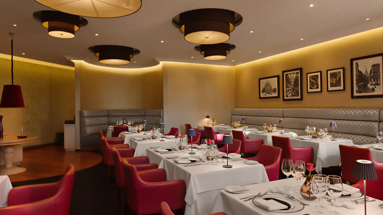 Elegancka restauracja w Olympic Lagoon Resort Paphos z nakrytymi stołami