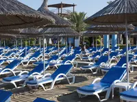 Leżaki pod parasolami na plaży w Quattro Beach Spa