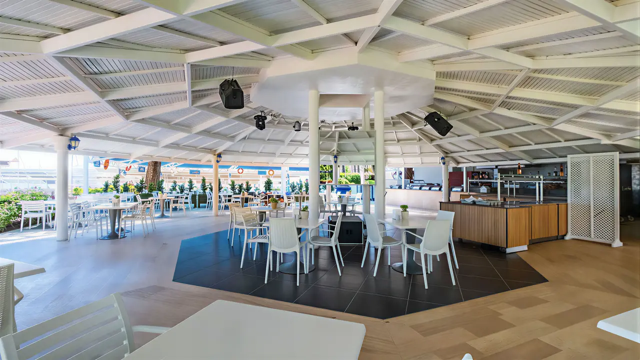 Restauracja w Queens Park Resort Goynuk z białymi stołami i krzesłami