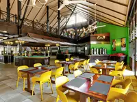 Restauracja w hotelu Senegambia Beach z żółtymi krzesłami