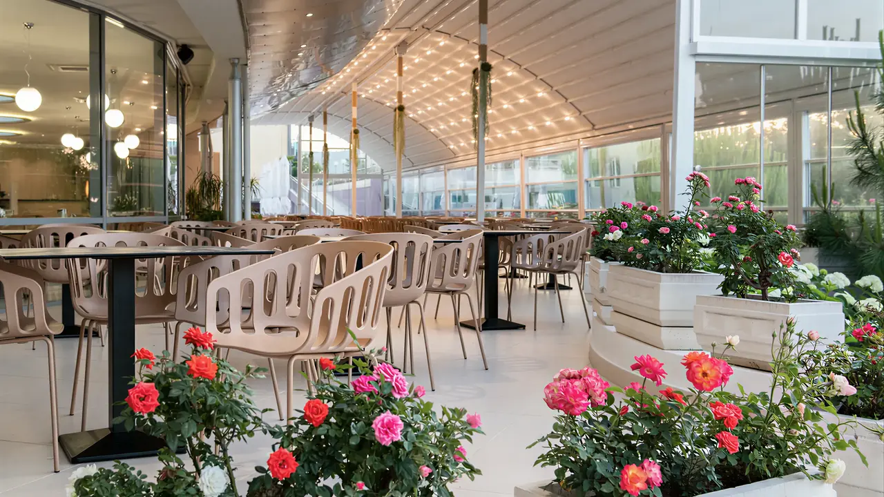 Restauracja w Sentido Neptun Beach z kwiatami i stolikami