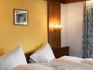 Łóżko w pokoju gościnnym Sporthotel Kurzras