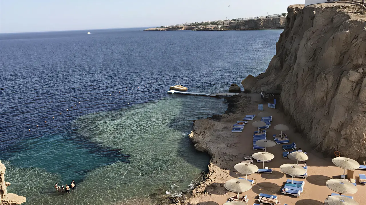 Plaża z leżakami i parasolami w Swiss Heaven Sharming Inn