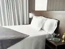 Łóżko w pokoju gościnnym w ThePlace Mariner