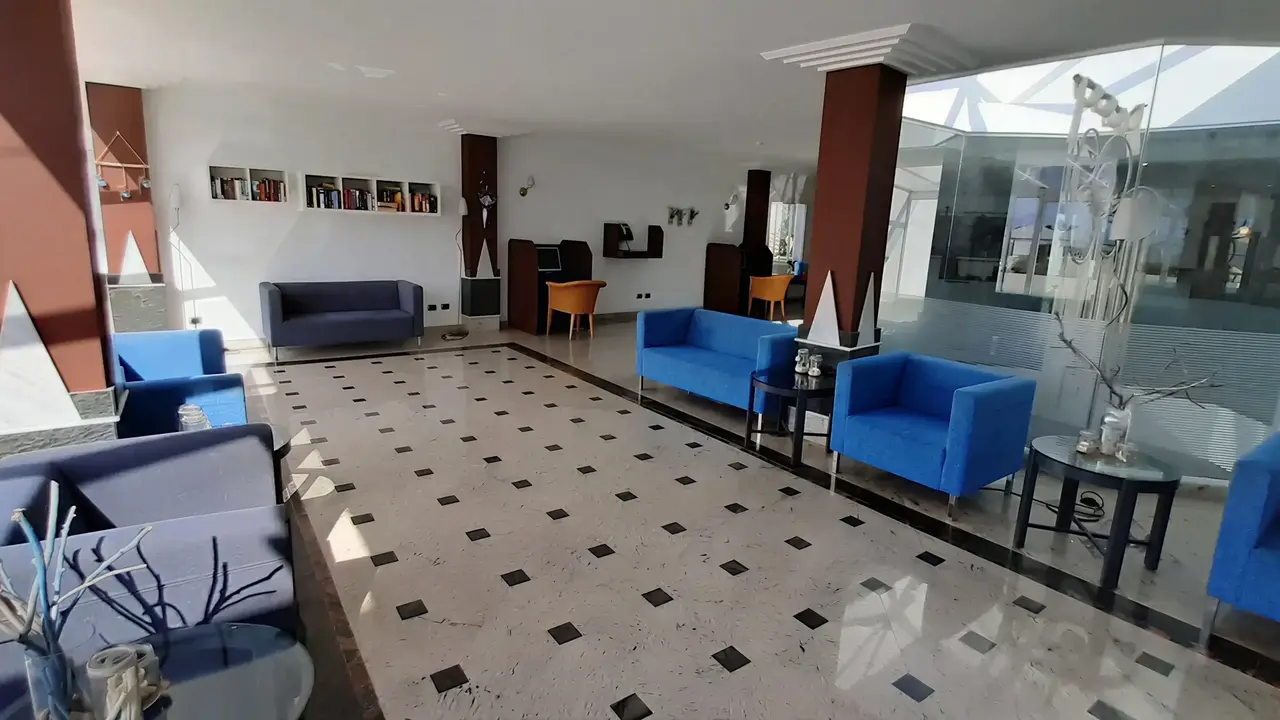 Nowoczesny lobby z niebieskimi kanapami w Turbo Club