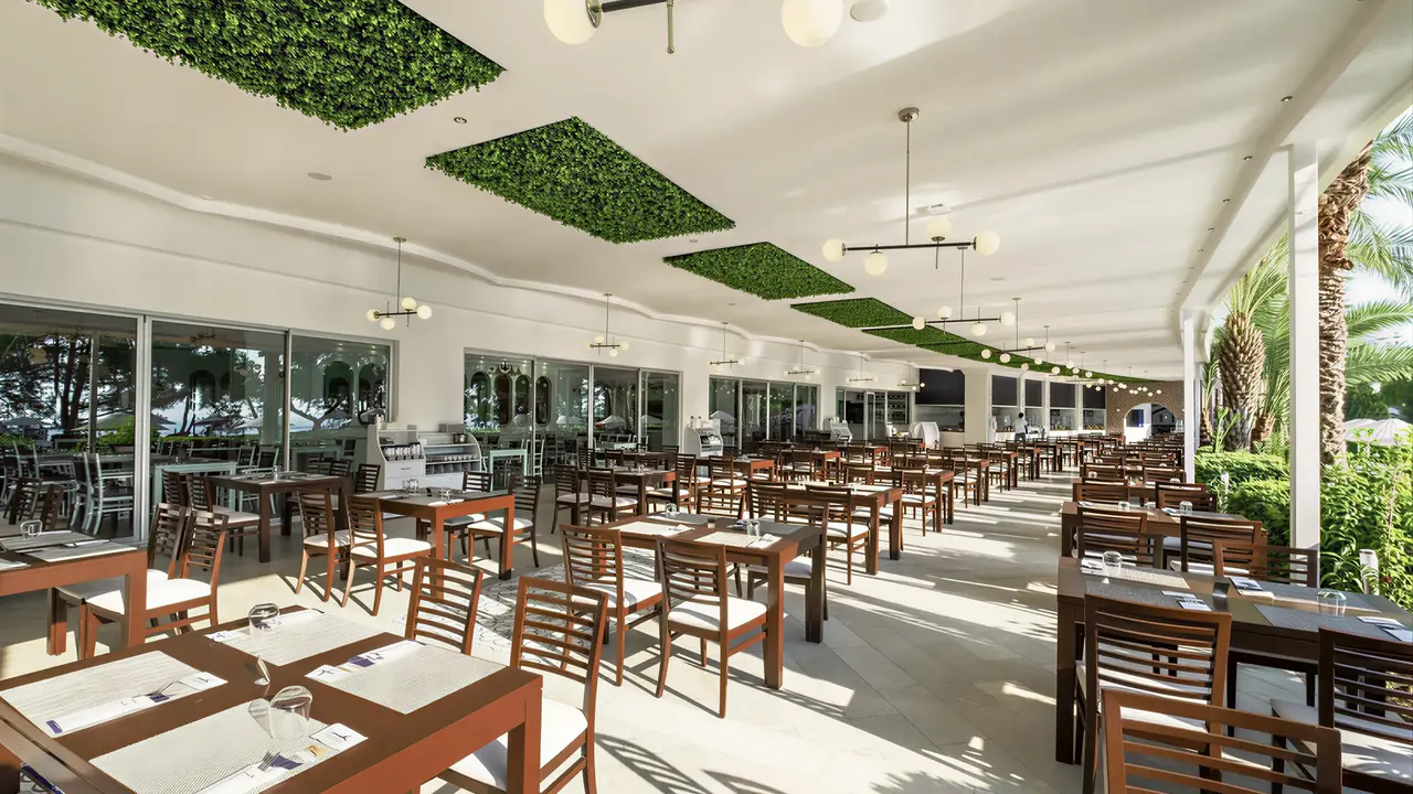 Restauracja w Utopia Beach Club z drewnianymi stołami
