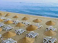 Leżaki i parasole na plaży w Yalihan Una